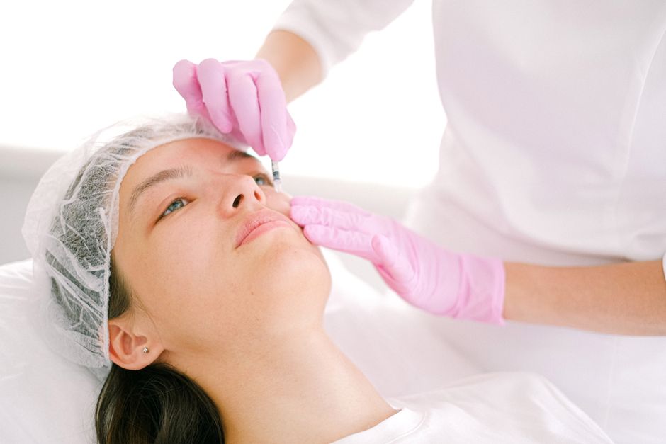 Dermatologist administering Botox injections to a patient's face at a Korean aesthetic clinic