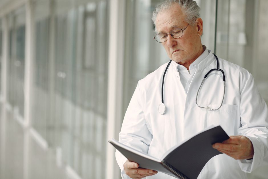 Patient reviewing English-language cancer screening results during recovery in Korea
