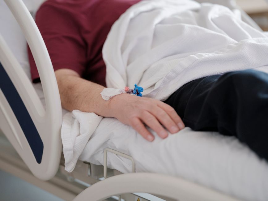 Patient resting in a monitored recovery area after a sedated colonoscopy in Korea