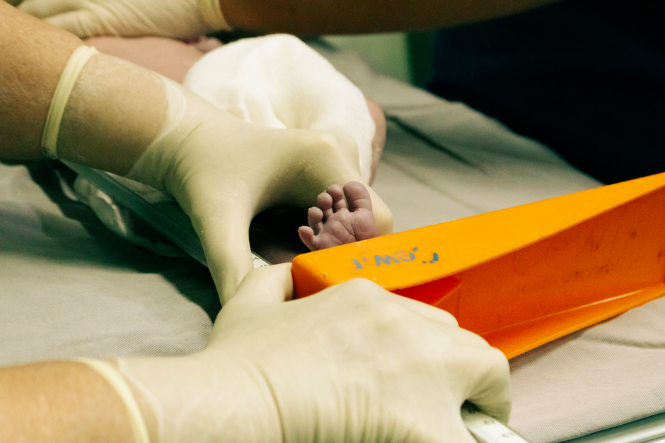 Neonatal care nurse attending to premature infant in NICU incubator at Korean tertiary hospital