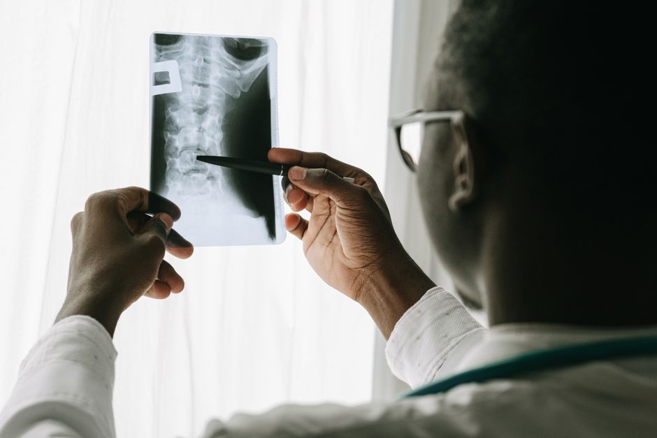 Spine surgeon reviewing scoliosis X-ray with patient before surgery in Korean hospital