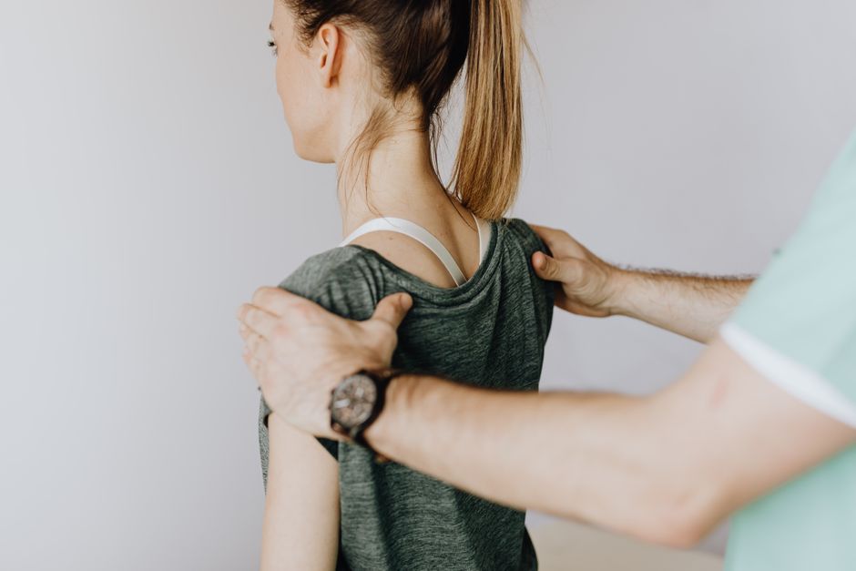 Patient recovering mobility with physiotherapist after spinal decompression surgery in South Korea
