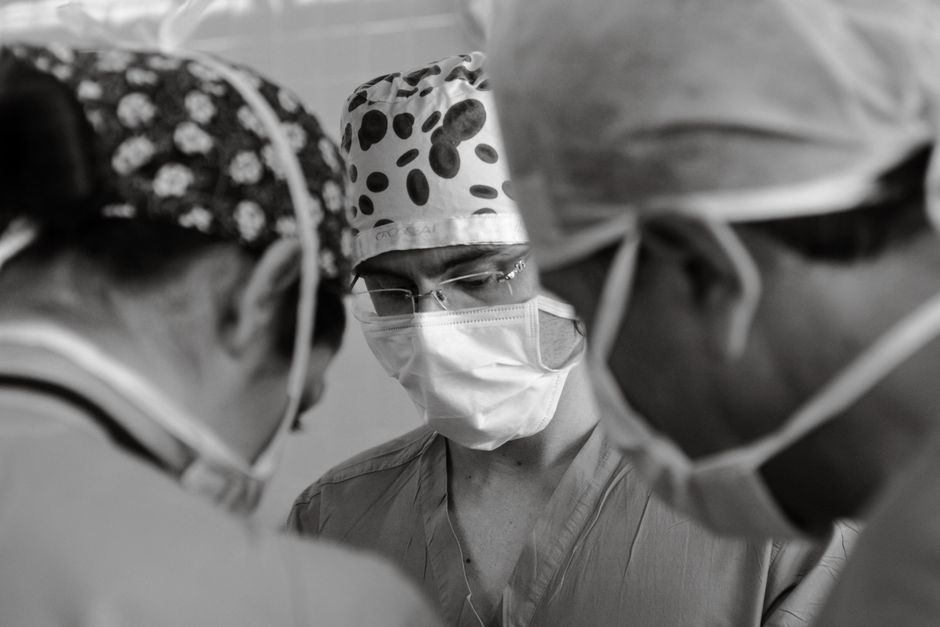 Surgical team performing abdominoplasty in an operating room in Korea